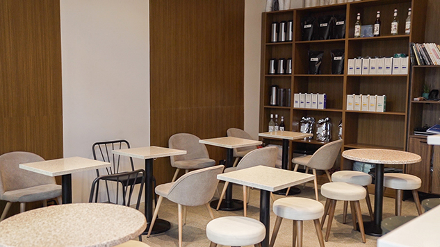 The aesthetic of the café revolves around warm and bright tropical colors to match Habitual's push for local coffee