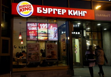 FILE PHOTO: Women walk outside a Burger King restaurant in Moscow, Russia