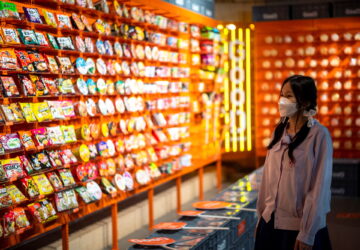 A student browses instant noodles at the Good Noodle store in Bangkok, Thailand