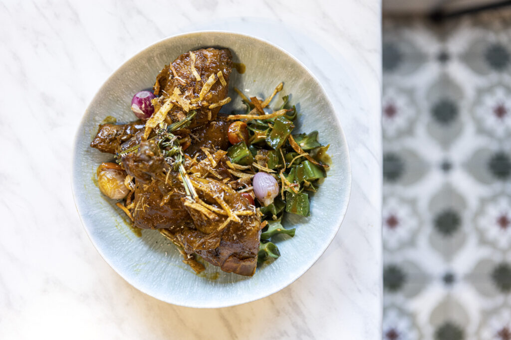 Burnt coconut chicken: Tender chicken thighs served with "burnt" coconut milk curry and a side of winged beans