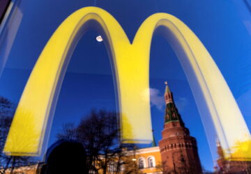 FILE PHOTO: A logo of the McDonald's restaurant is seen in the window with a reflection of Kremlin's tower in central Moscow, Russia