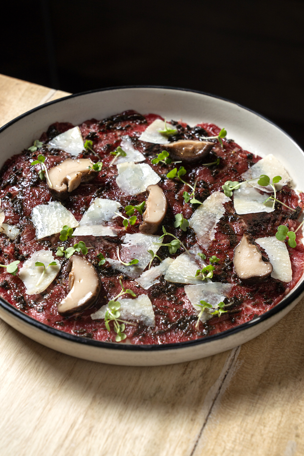 Beef tenderloin carpaccio with black truffle dressing and Parmesan
