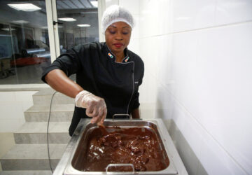 Viviane Kouame, Ivorian chocolate artisan who aims to promote country's origin, mixes chocolate paste during the production of chocolates at Chocovi, her chocolate factory in Abidjan, Ivory Coast