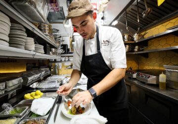 Chef Davide Sanna works in the kitchen of Piccola Cucina in the SoHo area of New York City, U.S., November 22, 2023. REUTERS/Brendan McDermid