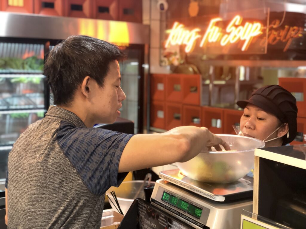 Inspecting and weighing the bowl of ingredients