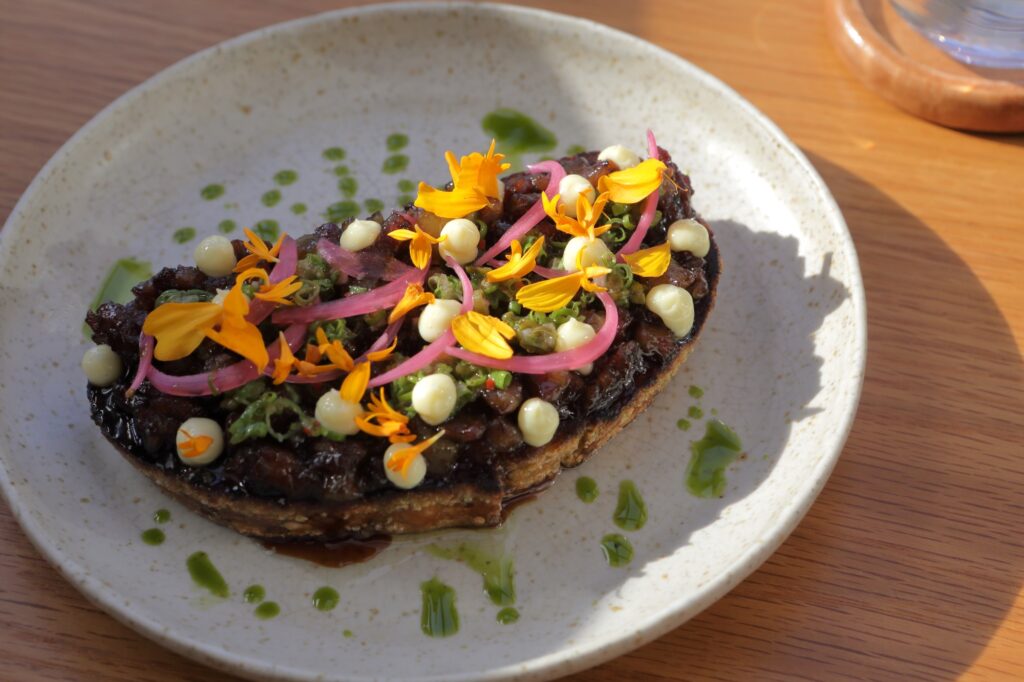 From the Ayà menu: Pares toast (beef and tendon pares jus, pan de kalinga sourdough toast, roasted garlic aioli, lasuna chimichurri)